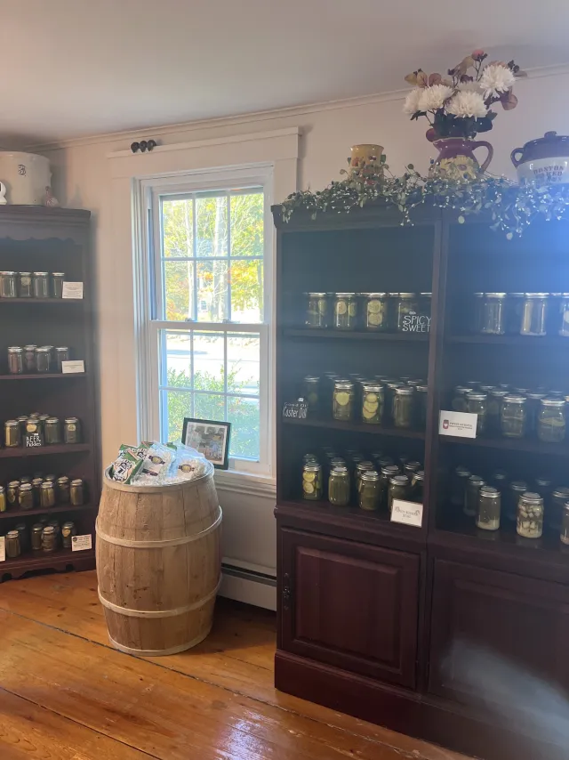 Shelves of canned goods and a pickle barrel in the country store